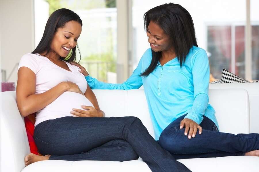 Pregnant Woman and Friend on Couch
